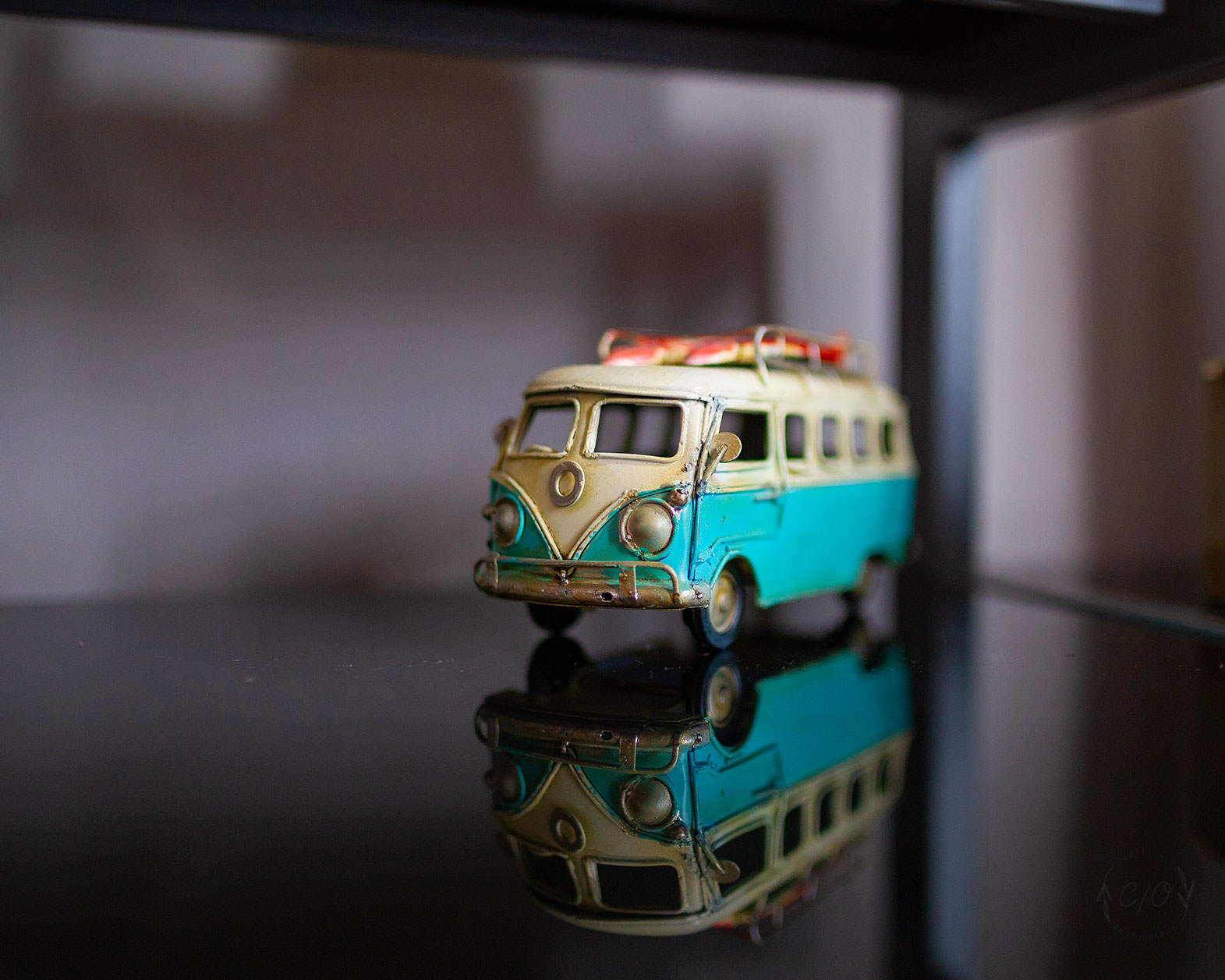 A Photograph of a Toy Kombi on a reflective surface